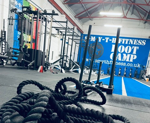 Battle ropes on the gym floor in front of the Smyth Fitness Boot Camp wall