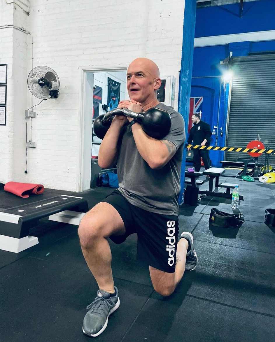 Man doing a lunge while holding a kettlebell