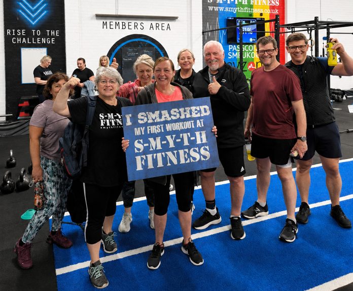 Group of new members celebrating their first workout
